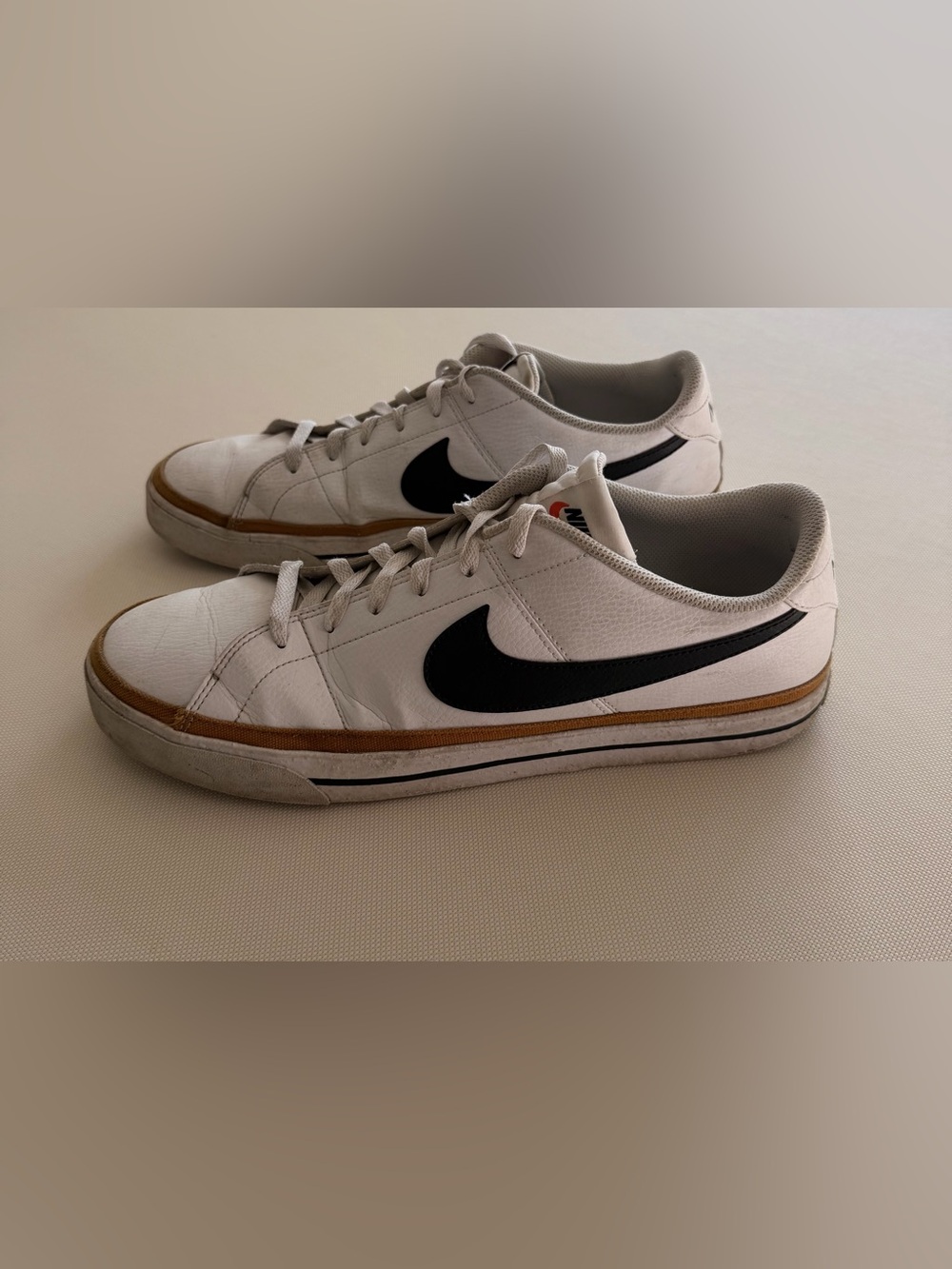 Nike Men’s White Leather Sneakers with Black Swoosh and Brown Accent
